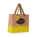 Promotional paper gift bag in yellow with printed logo